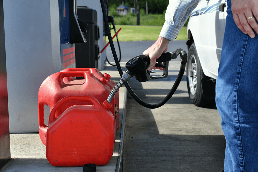 Person filling gas cans from a gas pump